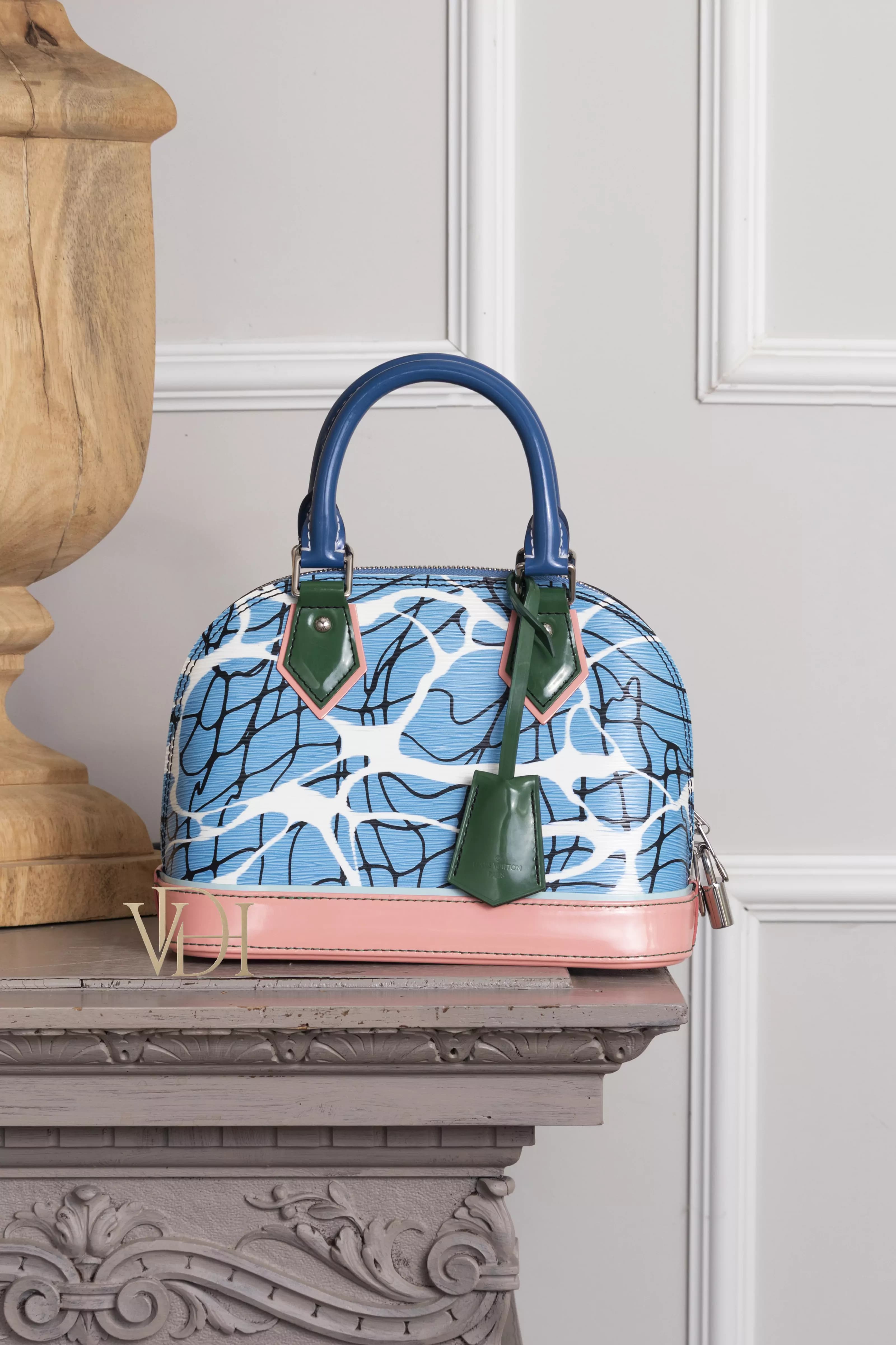 Louis Vuitton Alma BB Epi Aqua su camino di marmo grigio, vista frontale